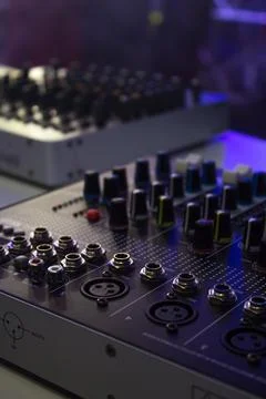 A DJ adjusts controls Stock Photos