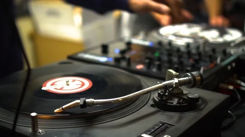 DJ adjusts the knobs and dials on his sound mixing deck 動画素材 109468911