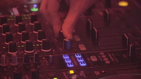  DJ adjusts sound during performance twists knobs musical equipment Stock Footage 126358552