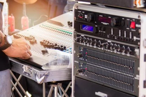 DJ are using their hands to adjust the volume and test the sound Stock Photos
