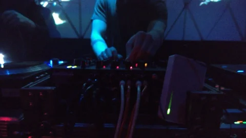 DJ behind the console, the other plugs the RJ-45 cable into the device 스톡 동영상 88452186