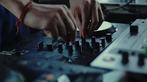 DJ carefully twisting the knobs of the mixer console during the live set 스톡 동영상 280141831