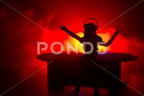Dj club concept. Woman DJ mixing, and Scratching in a Night Club. Girl silhou Stock Photos