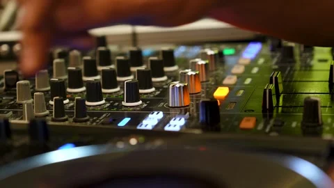 DJ at a Console Creating Music Pressing Buttons and Manipulating Knobs 動画素材 299632684