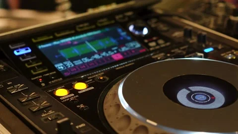 DJ at a Console Creating Music Pressing Buttons and Manipulating Knobs Stock Footage 299632872