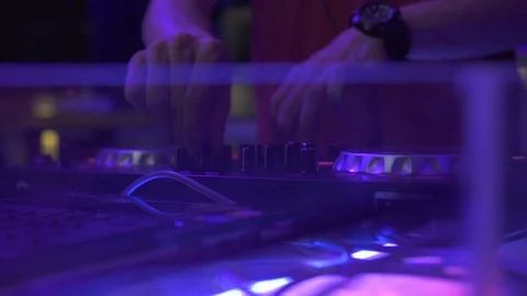 DJ console for mixing dance music and colorful light in disco club. DJ mixer Stock-Footage 107909314