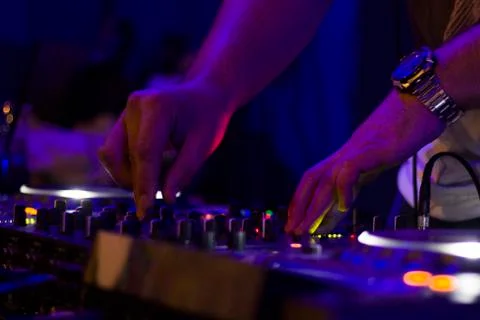 DJ controller and DJ hands, playing music scene. Color Light Music Instrument Stock Photos