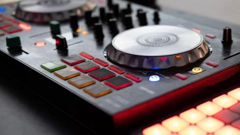 DJ controller close up view in live performance night club dance music. Stock Photos