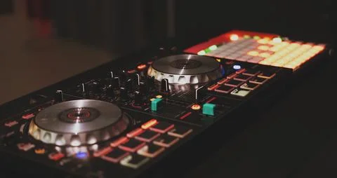 DJ controller close up view in live performance night club dance music. Stock Photos