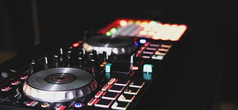 DJ controller close up view in live performance night club dance music. Stock Photos