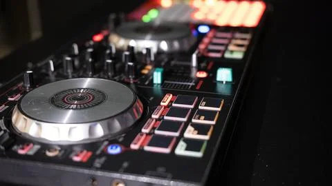 DJ controller close up view in live performance night club dance music. Stock Photos