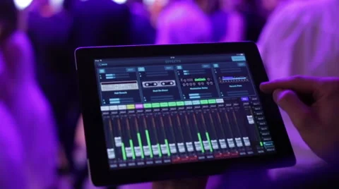 The DJ controls the music with the tablet and equalizer, Stock Footage 65498709
