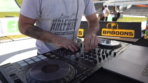 DJ controls the sound at an event, mixing music on a console to create an Stock Footage 337897561