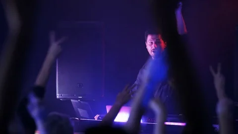 DJ Encouraging People to Dance Stock Footage 71813498