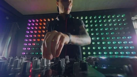 A DJ experiments with different knobs at his mixer. 스톡 동영상 79201513