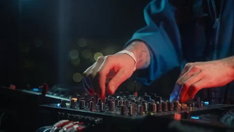 DJ gesturing on mixer at dark room event with musical entertainment Stock Footage 273823068