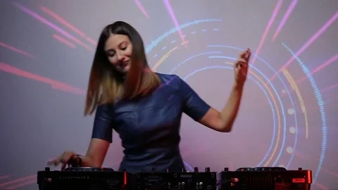 DJ girl on decks at the club Stock Footage