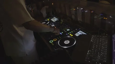 DJ Hand Adjusting Controls on Mixing Console Stock Footage 345021752