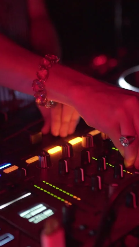 DJ Hand Adjusting Professional Audio Mixer During Nightclub Performance Stock Footage 337902626