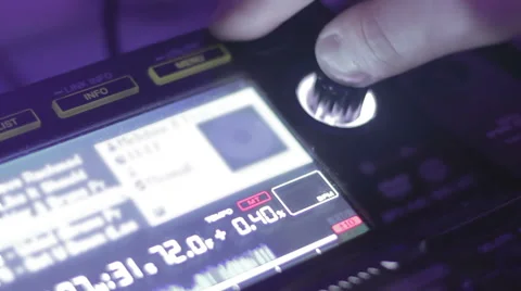 DJ hand pushing and turning button on the mixing console display, change tracks Stock Footage 61014760