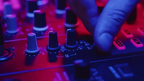 DJ hand switches toggle switch on console and turns knobs for mixing music in Video stock 172313274