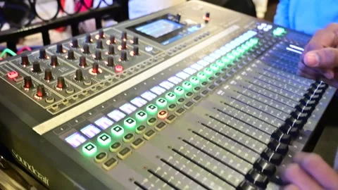 DJ hand tweaking knobs on Soundcraft mixer music in clubbing scene 動画素材 295935007