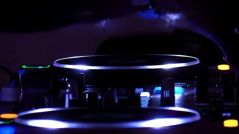DJ handling buttons on mixing console at night Stock-Footage 105488536