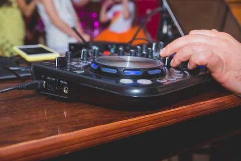 DJ Hands creating and regulating music on dj console mixer in concert outdoor.DJ Stock Photos