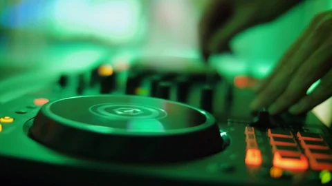 DJ hands touching buttons sliders, playing electronic music on mixing deck Stock Footage 111276816