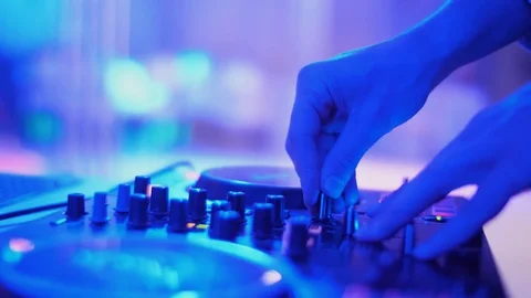 DJ hands touching buttons sliders, playing electronic music on mixing deck Video stock 111276852