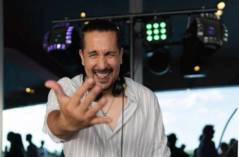 DJ interacting with the camera and the crowd during a lively performance. S.. Stock Photos