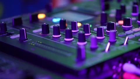 DJ Mixer Console with Glowing Knobs in Neon Light Close Up Video stock 336783014