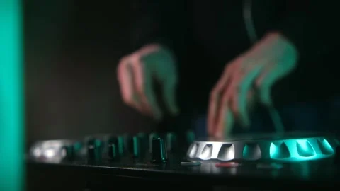Dj mixing and scratching on a turntable controller at a nightclub Stock Footage 337830599
