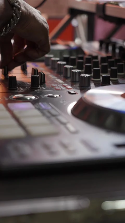 DJ Mixing Console with Hands in Action, showcasing artistry and creativity in Stock Footage 316513044
