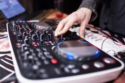 DJ mixing music on console at the night club Stock Photos