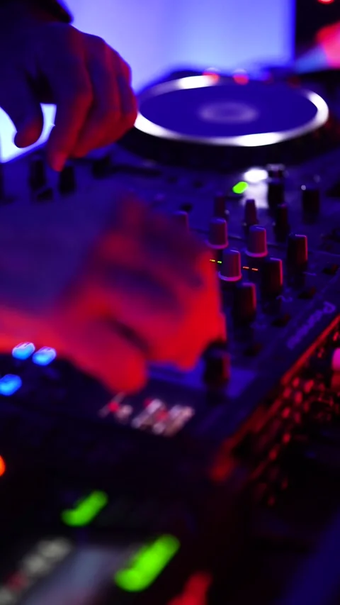 Dj mixing music on controller deck at nightclub party Stock Footage 333562806