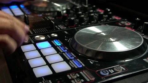DJ Mixing Music with Digital Controller Turning Knobs 動画素材 136345545