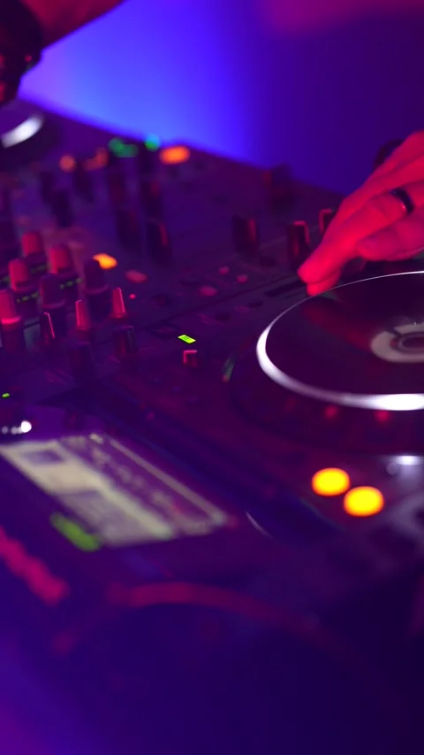 Dj mixing music on a turntable console in a nightclub Stock Footage 333562906