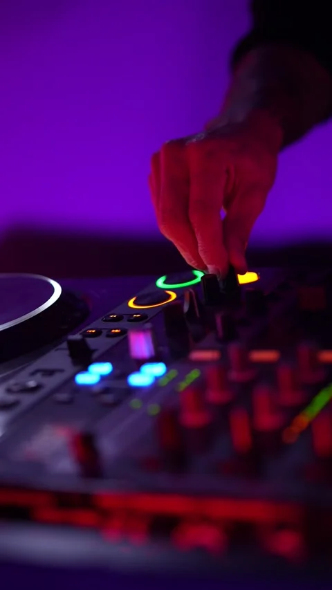 Dj mixing music on a turntable controller at a nightclub party Stock Footage 325493136