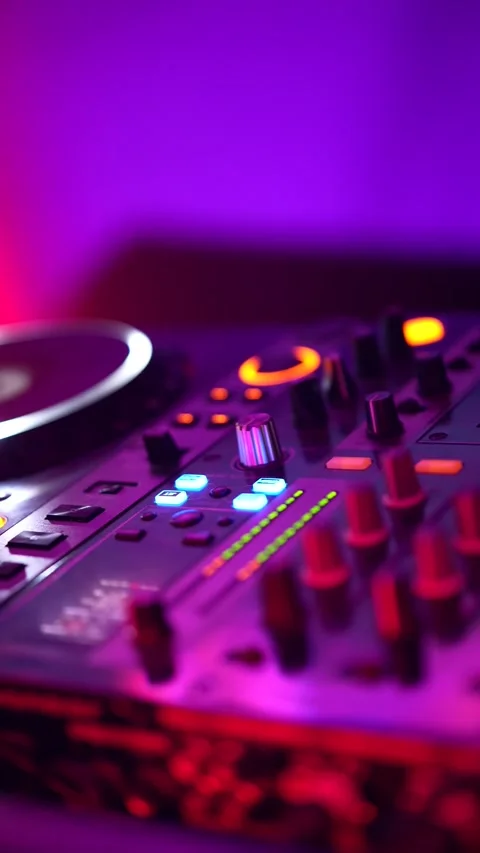 Dj mixing music on a turntable controller at a nightclub party Stock Footage 325493213