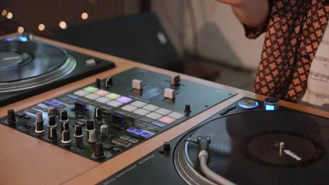 DJ Mixing Session featuring both Turntables and a Controller for an electric Stock Footage 314577459