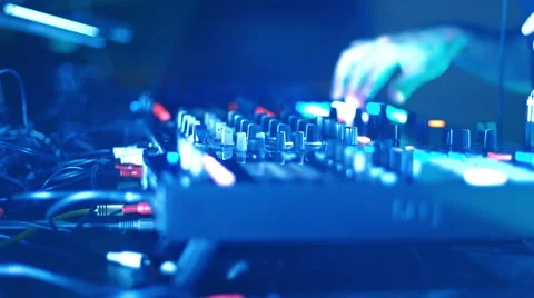 DJ mixing tracks on console at dance music party Stock Footage 50346964