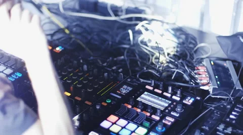 DJ mixing tracks on console at dance music party Stock Footage 50347097