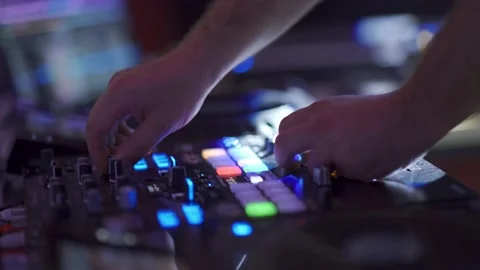 DJ in a nightclub near the console.dj standing at the mixer controller Stock Footage