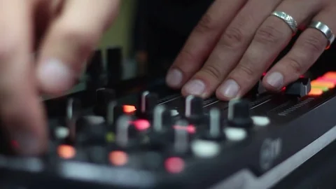 DJ operates using an audio mixer Stock Footage 72705010