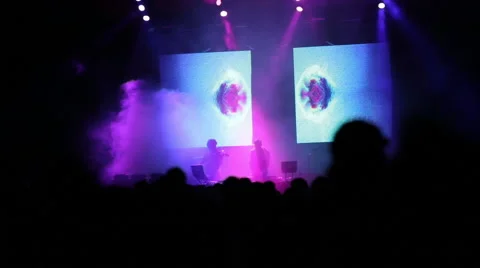 DJ performing on stage under digital art show Stock-Footage 49679200