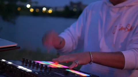 DJ playing drumpads in front of lake, Copenhagen Video stock 149753289