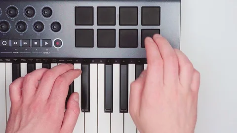 The DJ is playing on the midi keyboard. A drum machine. Top view. 4k. Stock-Footage 89123740