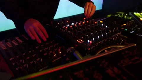 Dj playing at night club with digital midi controllers and mixers Stock Footage