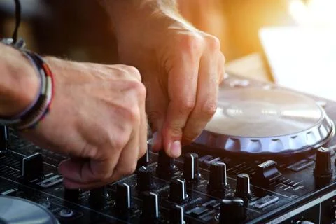 DJ playing on professional mixing controller. Stock Photos